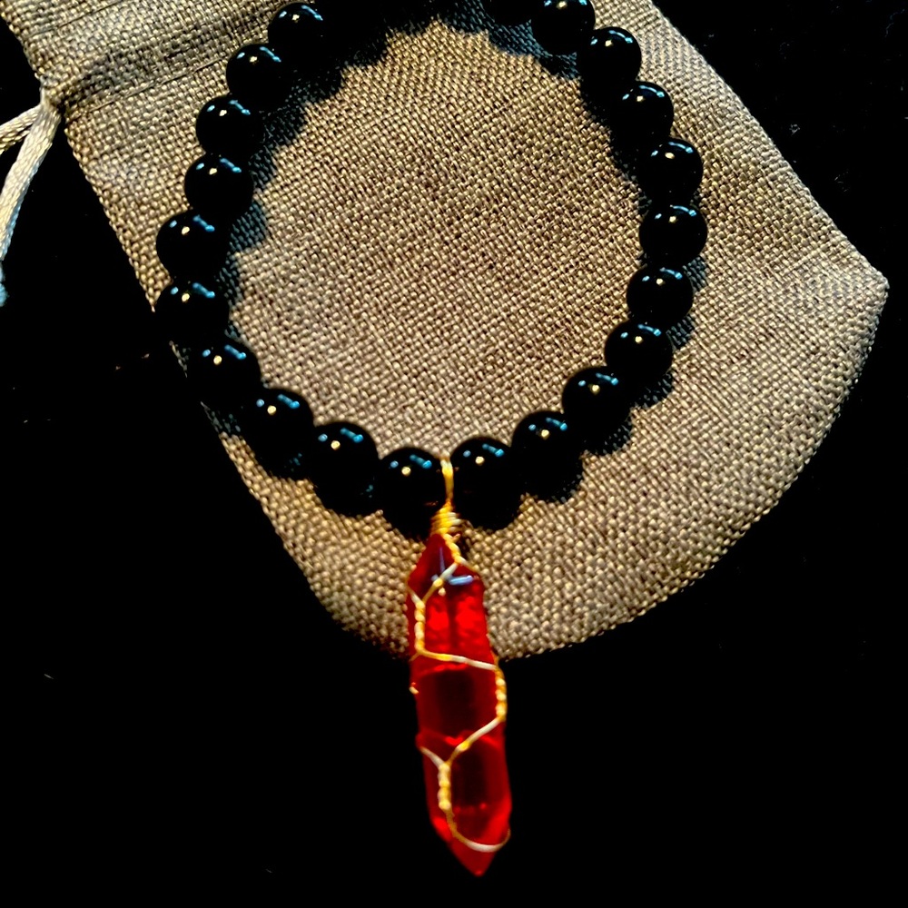 Hand beaded black obsidian bracelet with ruby pyramid charm.